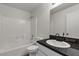 Bathroom featuring a vanity with a black countertop and a shower and tub combo at 6117 Daisy Lee Ave, Las Vegas, NV 89108