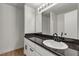 Bathroom featuring vanity with a black countertop and undermount sink at 6117 Daisy Lee Ave, Las Vegas, NV 89108