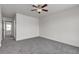 This carpeted bedroom includes a ceiling fan and an entry to another room at 6117 Daisy Lee Ave, Las Vegas, NV 89108