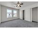 This carpeted bedroom has two windows and a closet with sliding doors at 6117 Daisy Lee Ave, Las Vegas, NV 89108