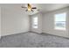 Spacious bedroom with three windows, ceiling fan, carpet and neutral paint at 6117 Daisy Lee Ave, Las Vegas, NV 89108