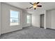 Neutral bedroom with a ceiling fan, two windows and a closet at 6117 Daisy Lee Ave, Las Vegas, NV 89108