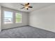 Bright bedroom with a ceiling fan and two windows at 6117 Daisy Lee Ave, Las Vegas, NV 89108