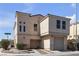 Two-story home boasts a private two-car garage and low maintenance desert landscaping in front at 6117 Daisy Lee Ave, Las Vegas, NV 89108