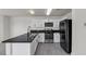 Modern kitchen featuring sleek countertops, stainless appliances, and white cabinets at 6117 Daisy Lee Ave, Las Vegas, NV 89108