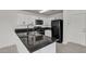 Modern kitchen featuring ample cabinet space, stainless appliances, and sleek granite countertops at 6117 Daisy Lee Ave, Las Vegas, NV 89108