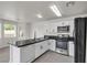 Modern kitchen featuring a black refrigerator, an oven, and granite countertops at 6117 Daisy Lee Ave, Las Vegas, NV 89108