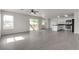 Open-concept living room with sliding door access to the backyard, adjacent to the modern kitchen at 6117 Daisy Lee Ave, Las Vegas, NV 89108