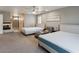Spacious main bedroom with two beds, modern decor, and a cozy chaise lounge at 6251 Tuckaway Cove Ave, Las Vegas, NV 89139