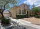 Charming two-story home with a two-car garage, desert landscaping, and a spacious driveway at 6797 Cardoness Ct, Las Vegas, NV 89139