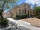 Charming two-story home with a two-car garage, desert landscaping, and a spacious driveway at 6797 Cardoness Ct, Las Vegas, NV 89139
