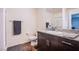A well-lit bathroom with granite countertop vanity and a shower at 6819 Citron Mist Ct, North Las Vegas, NV 89086