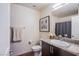 Cozy bathroom featuring a granite vanity top, framed mirror, and shower with gray curtain at 6819 Citron Mist Ct, North Las Vegas, NV 89086