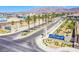 A beautiful Primary-planned community entrance with palm trees and desert landscaping at 6819 Citron Mist Ct, North Las Vegas, NV 89086