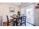 Bright dining room featuring a modern table setting and access to an outdoor balcony through sliding doors at 6819 Citron Mist Ct, North Las Vegas, NV 89086