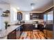 Modern kitchen with granite countertops, stainless steel appliances, and stylish wood-look flooring at 6819 Citron Mist Ct, North Las Vegas, NV 89086