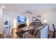 Spacious living room with modern furnishings, TV, natural lighting, and stylish decor at 6819 Citron Mist Ct, North Las Vegas, NV 89086