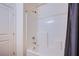 Spotless shower and tub showcasing white tile, shower head, and chrome fixtures at 6819 Citron Mist Ct, North Las Vegas, NV 89086