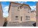View of the exterior and backyard featuring a stucco wall, door and windows, and a rock covered yard at 69 Ella Ashman Ave, Henderson, NV 89011