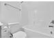 This bathroom features a white toilet, white shower-tub combo and tile surround at 69 Ella Ashman Ave, Henderson, NV 89011