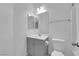 Bathroom featuring gray vanity, single sink, and white toilet at 69 Ella Ashman Ave, Henderson, NV 89011