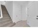 Entryway showcases a staircase, neutral tile flooring, and a front door with secure entry at 69 Ella Ashman Ave, Henderson, NV 89011