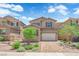 Charming two-story home featuring a brick driveway, manicured lawn and neutral color palette at 69 Ella Ashman Ave, Henderson, NV 89011
