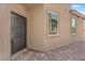 A close-up of a home's entryway featuring a secure black door and brick accents at 69 Ella Ashman Ave, Henderson, NV 89011