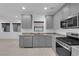 Modern kitchen features stainless steel appliances, granite countertops, and gray cabinets at 69 Ella Ashman Ave, Henderson, NV 89011