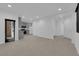 An open-concept living area with tile flooring and gray kitchen featuring modern appliances at 69 Ella Ashman Ave, Henderson, NV 89011