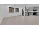 An open-concept living area with tile flooring and gray kitchen featuring modern appliances at 69 Ella Ashman Ave, Henderson, NV 89011