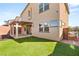 This backyard features a covered patio, artificial grass and low-maintenance landscaping at 6901 Whisper Canyon Pl, North Las Vegas, NV 89084