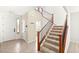 Inviting foyer with staircase, neutral tile floors, and natural light from the sidelight window at 6901 Whisper Canyon Pl, North Las Vegas, NV 89084