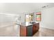 Bright kitchen island with sink and stainless steel dishwasher, open to living area with natural light at 6901 Whisper Canyon Pl, North Las Vegas, NV 89084