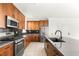 Modern kitchen with stainless steel appliances, tiled backsplash, and custom cabinets at 6901 Whisper Canyon Pl, North Las Vegas, NV 89084