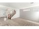 Bright open-concept living room with staircase and large windows at 6901 Whisper Canyon Pl, North Las Vegas, NV 89084