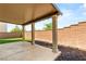 Covered patio with substantial support pillars, concrete floor, and privacy wall at 6901 Whisper Canyon Pl, North Las Vegas, NV 89084