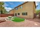Cozy backyard with artificial grass, gravel, picnic table, and access to the house, perfect for entertaining at 7372 S Palo Real Ct, Las Vegas, NV 89179
