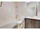 This bathroom includes a shower/tub combo, toilet, mirror and a dark wood cabinet at 7372 S Palo Real Ct, Las Vegas, NV 89179