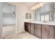 Bathroom with double vanity, framed mirrors, and views to the bedroom and shower at 7372 S Palo Real Ct, Las Vegas, NV 89179