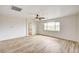 Spacious bedroom featuring wood-look flooring, ceiling fan, and natural light at 7372 S Palo Real Ct, Las Vegas, NV 89179