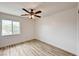 Bright bedroom with a large window and modern ceiling fan at 7372 S Palo Real Ct, Las Vegas, NV 89179