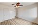 Bedroom featuring a closet with sliding doors and light wood flooring at 7372 S Palo Real Ct, Las Vegas, NV 89179