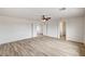 Bright bedroom with wood-look flooring, ceiling fan, and ensuite bathroom at 7372 S Palo Real Ct, Las Vegas, NV 89179