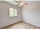 A bedroom with white walls, a ceiling fan and hardwood floors at 7372 S Palo Real Ct, Las Vegas, NV 89179