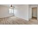 Bright bedroom with ceiling fan, wood-look flooring, and ample space at 7372 S Palo Real Ct, Las Vegas, NV 89179