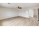 Bedroom featuring wood-look floors, ceiling fan, and adjoining rooms at 7372 S Palo Real Ct, Las Vegas, NV 89179