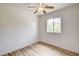 A bedroom with white walls, a ceiling fan and hardwood floors at 7372 S Palo Real Ct, Las Vegas, NV 89179