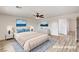 Staged bedroom with wood-look floors, a ceiling fan, and decor at 7372 S Palo Real Ct, Las Vegas, NV 89179