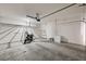 Spacious garage with high ceilings, overhead storage racks, and ample space for parking and projects at 7372 S Palo Real Ct, Las Vegas, NV 89179